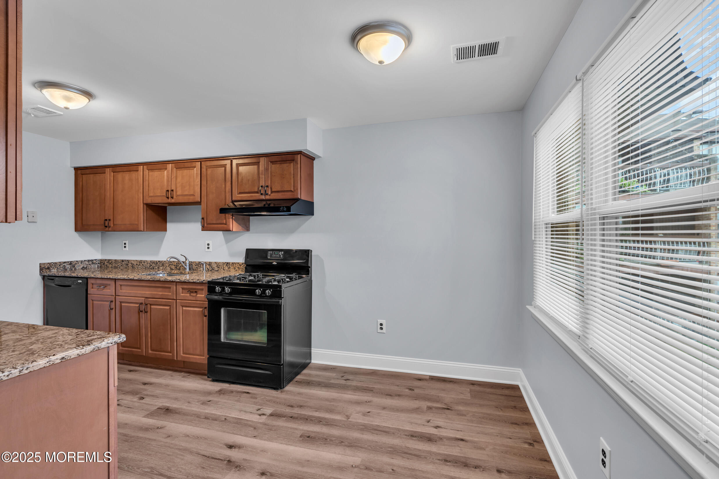 1617 Raspberry Court Edison, NJ 08817 - Photo 13 of 29 a kitchen with granite countertop wooden floors and stainless steel appliances