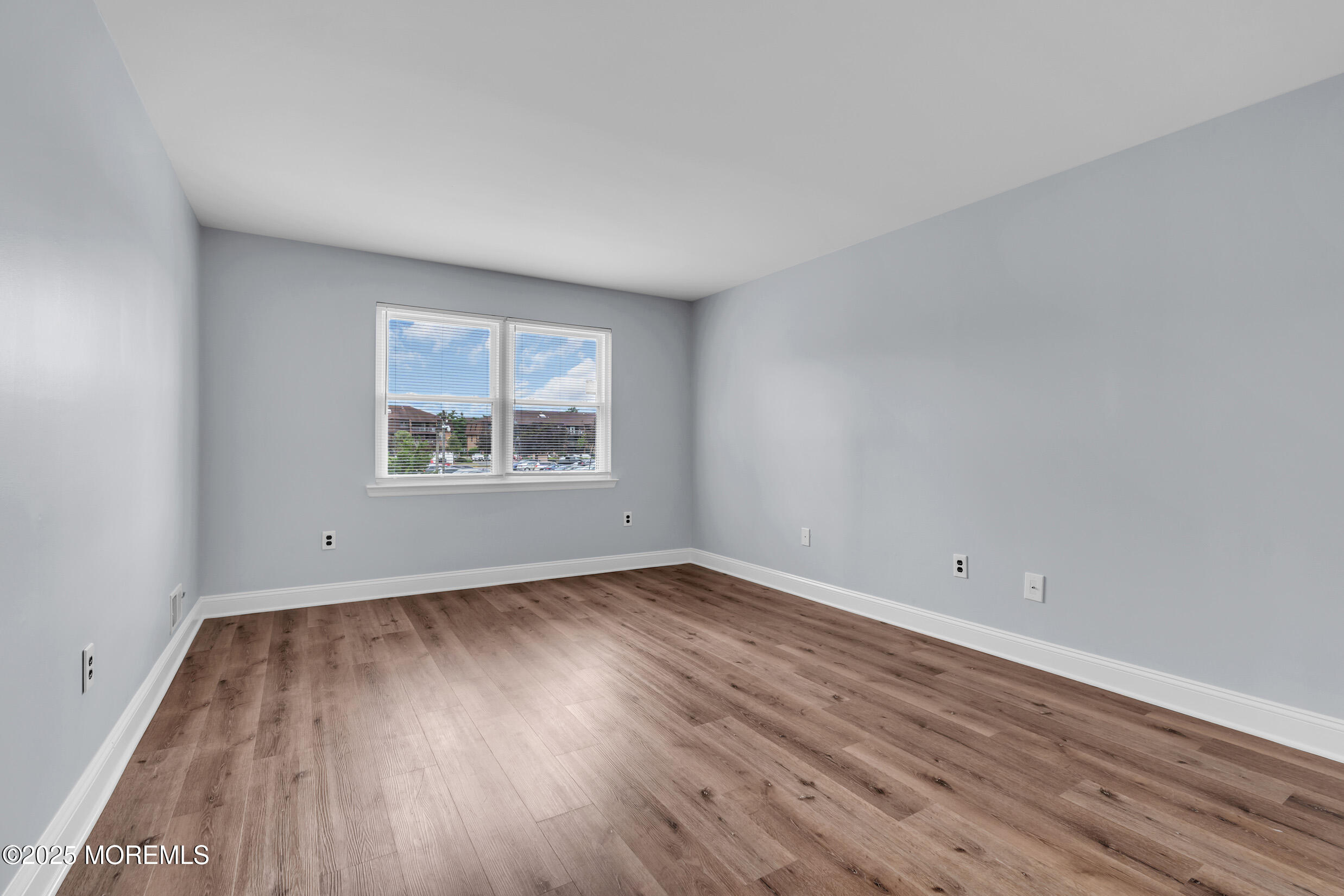 1617 Raspberry Court Edison, NJ 08817 - Photo 15 of 29 an empty room with wooden floor and windows