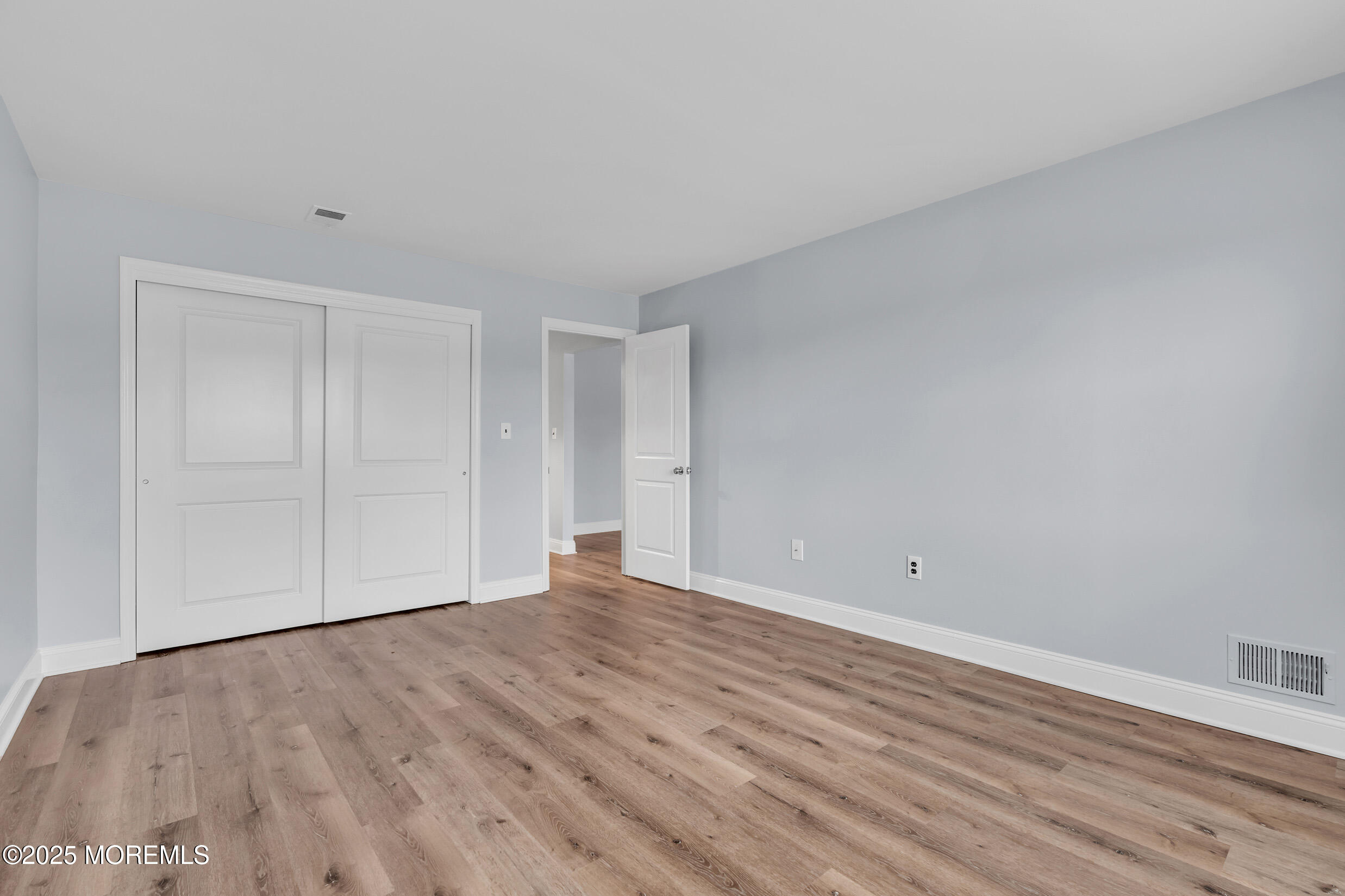 1617 Raspberry Court Edison, NJ 08817 - Photo 16 of 29 a view of an empty room with wooden floor