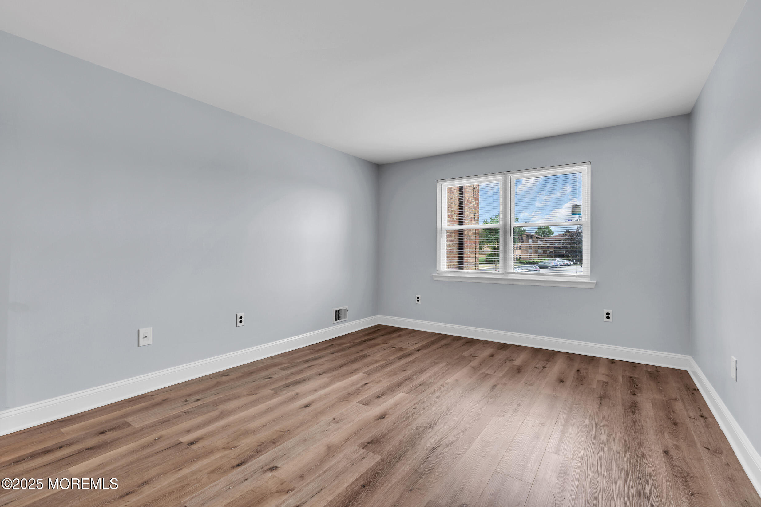 1617 Raspberry Court Edison, NJ 08817 - Photo 18 of 29 an empty room with wooden floor and windows