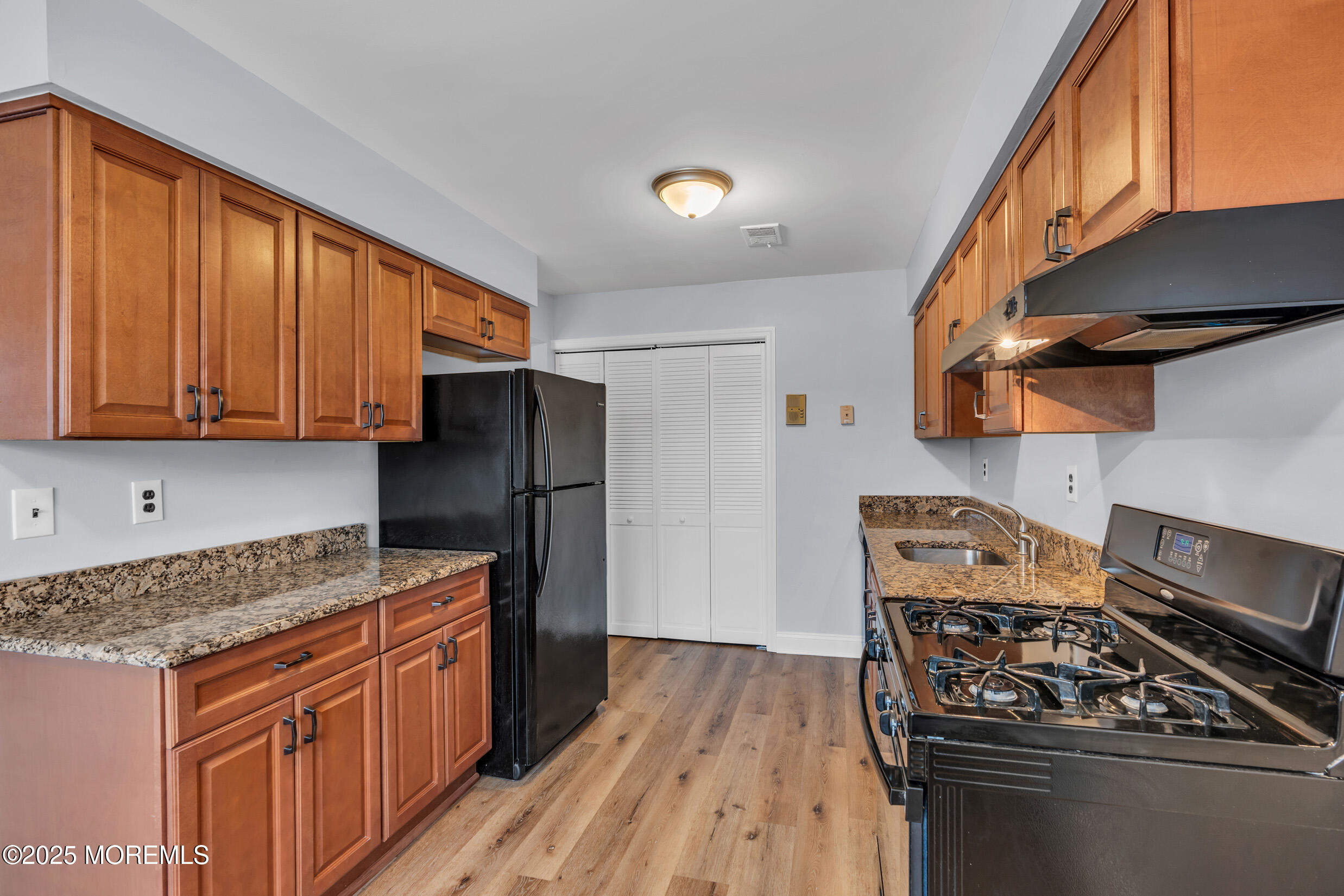 1617 Raspberry Court Edison, NJ 08817 - Photo 2 of 29 a kitchen with stainless steel appliances granite countertop a stove a sink dishwasher and a refrigerator with wooden cabinets