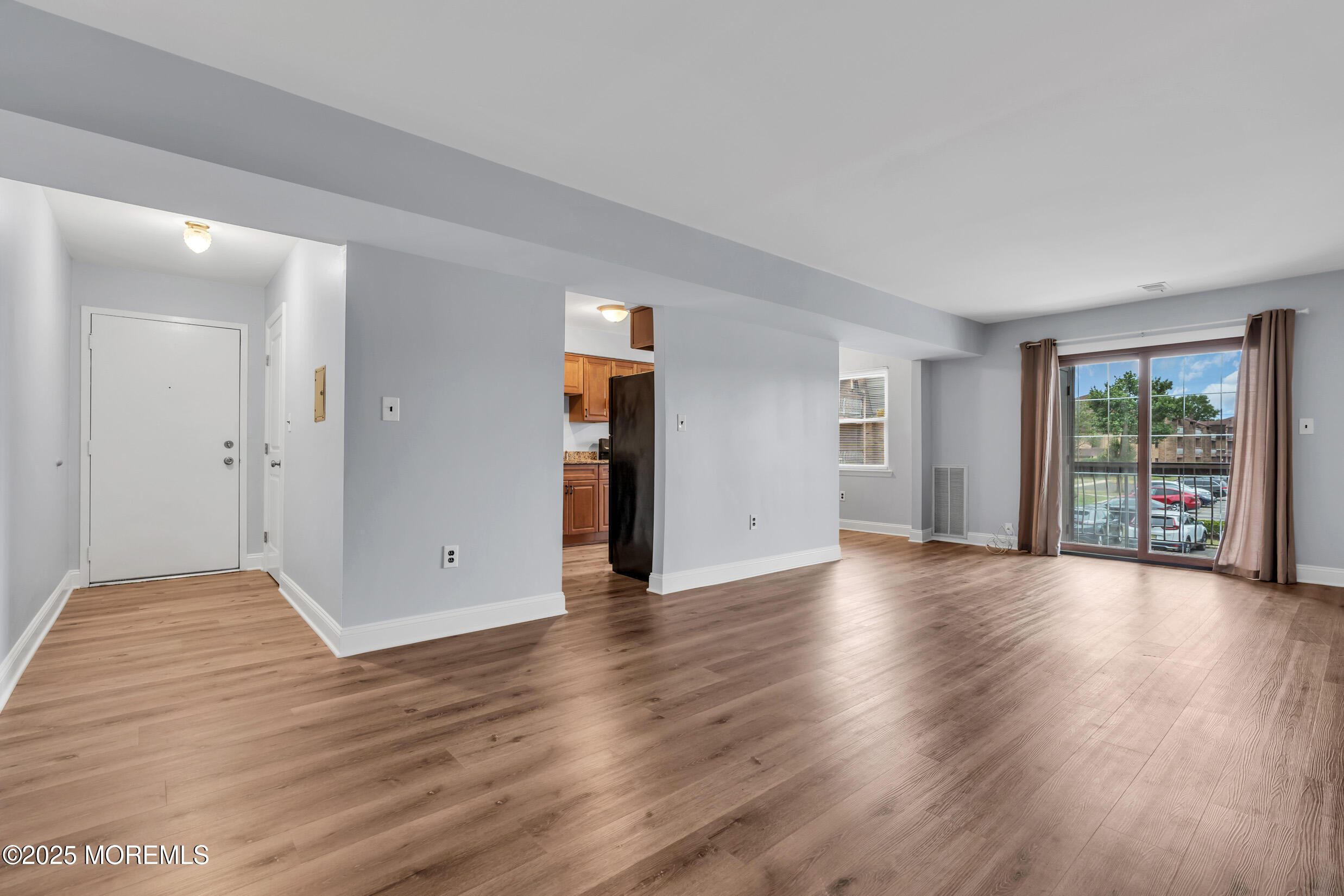1617 Raspberry Court Edison, NJ 08817 - Photo 10 of 29 a view of an empty room with wooden floor and a window