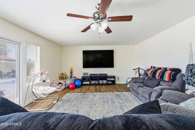 a living room with furniture and a flat screen tv