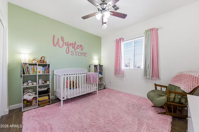 a bedroom with furniture and a book shelf