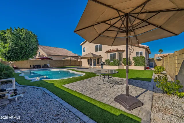 a view of a table and chairs under an umbrella