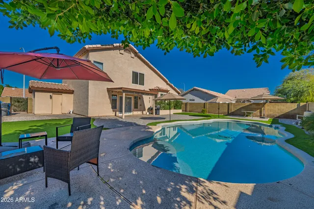 a view of a house with pool porch and chairs