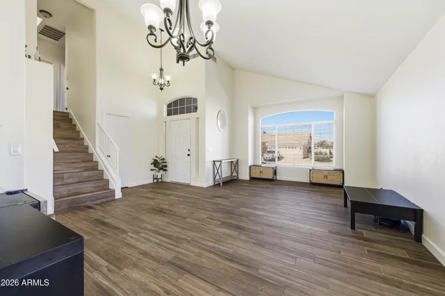 a view of a livingroom with wooden floor and stairs