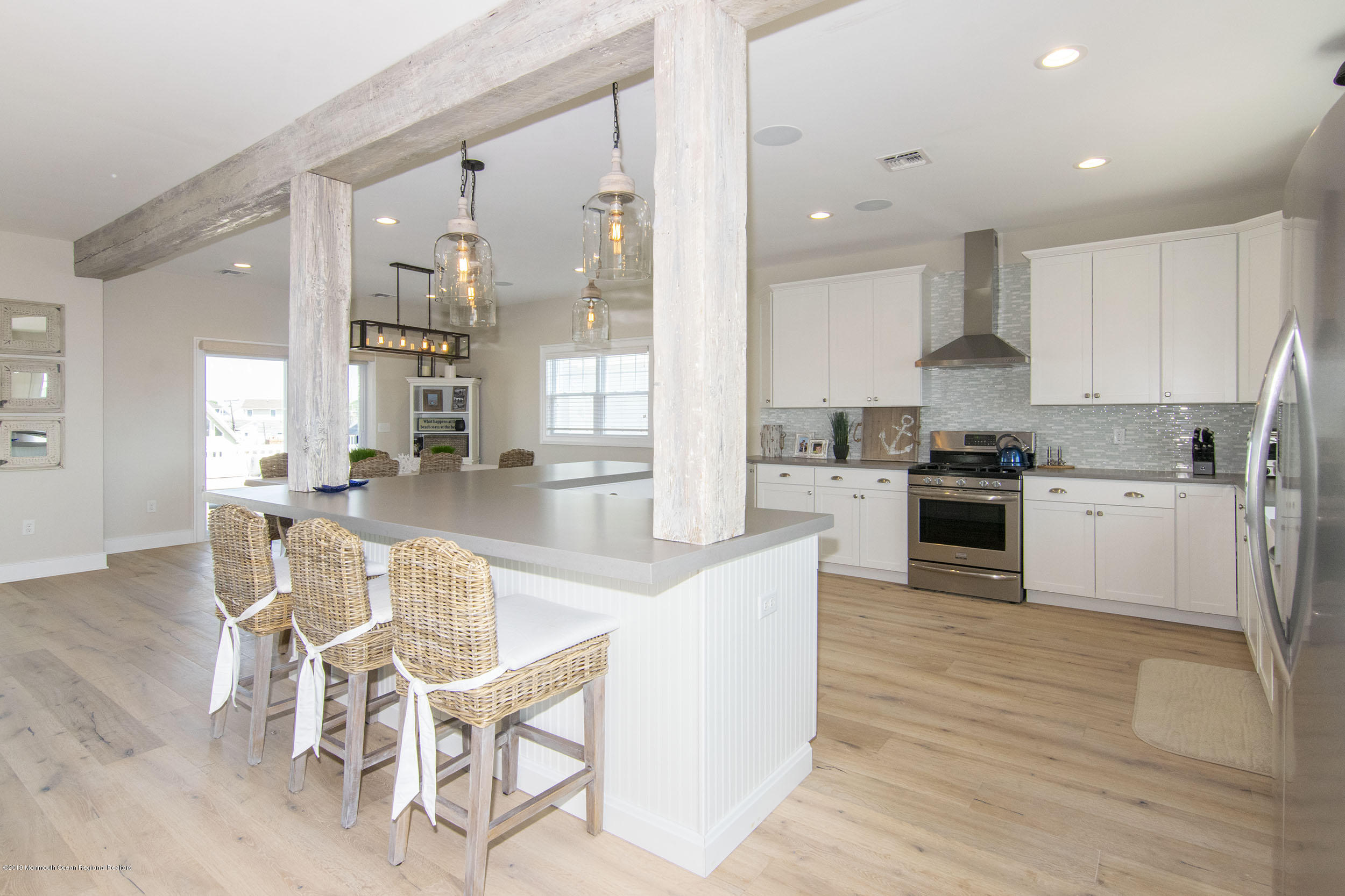 30 Ward Drive Brick, NJ 08723 - Photo 19 of 61 a kitchen with stainless steel appliances kitchen island granite countertop a stove a sink a refrigerator and white cabinets with wooden floor