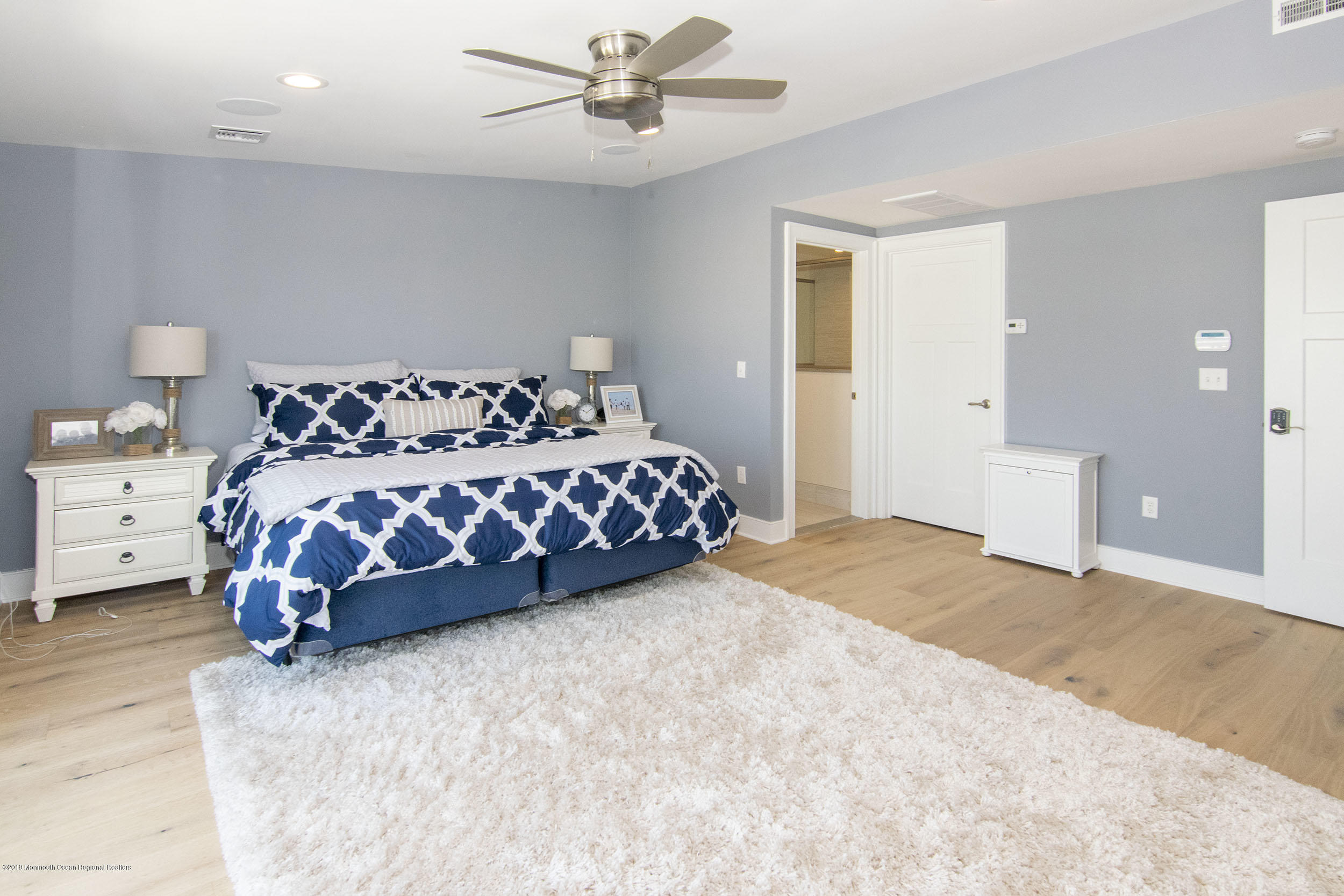 30 Ward Drive Brick, NJ 08723 - Photo 32 of 61 a large bed sitting in a bedroom next to a window and a chandelier
