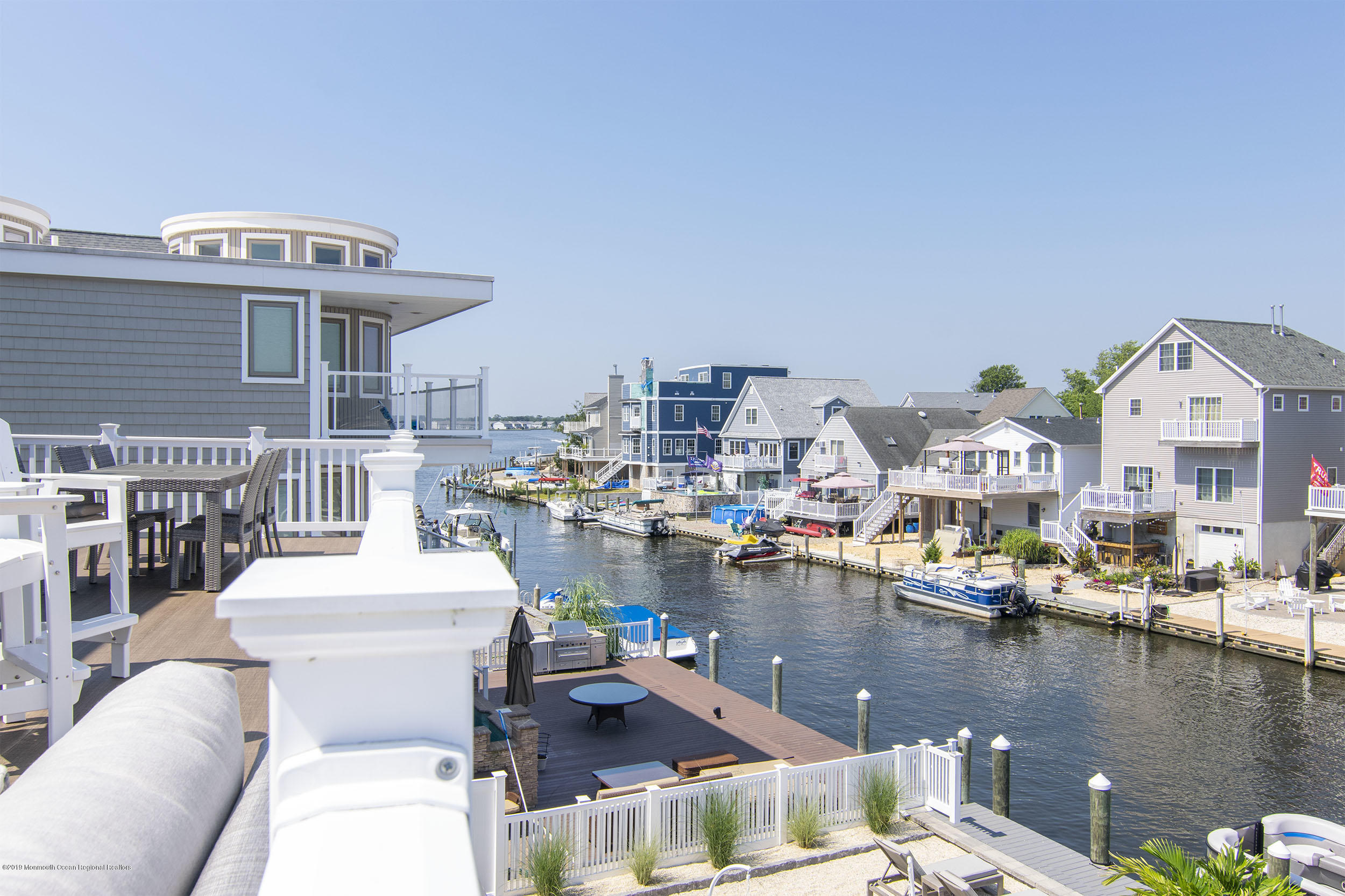 30 Ward Drive Brick, NJ 08723 - Photo 36 of 61 a balcony with lots of white furniture and water view