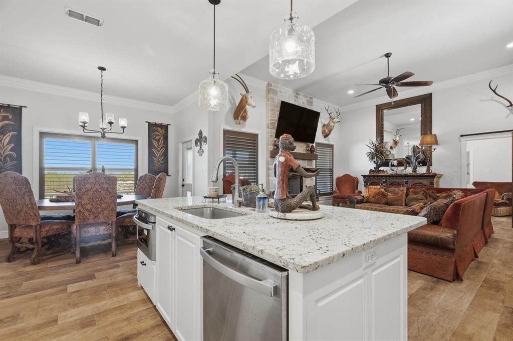 163 Homestead Road Tuscola, TX 79562 - Photo 11 of 40 a view of kitchen island dining table and chairs