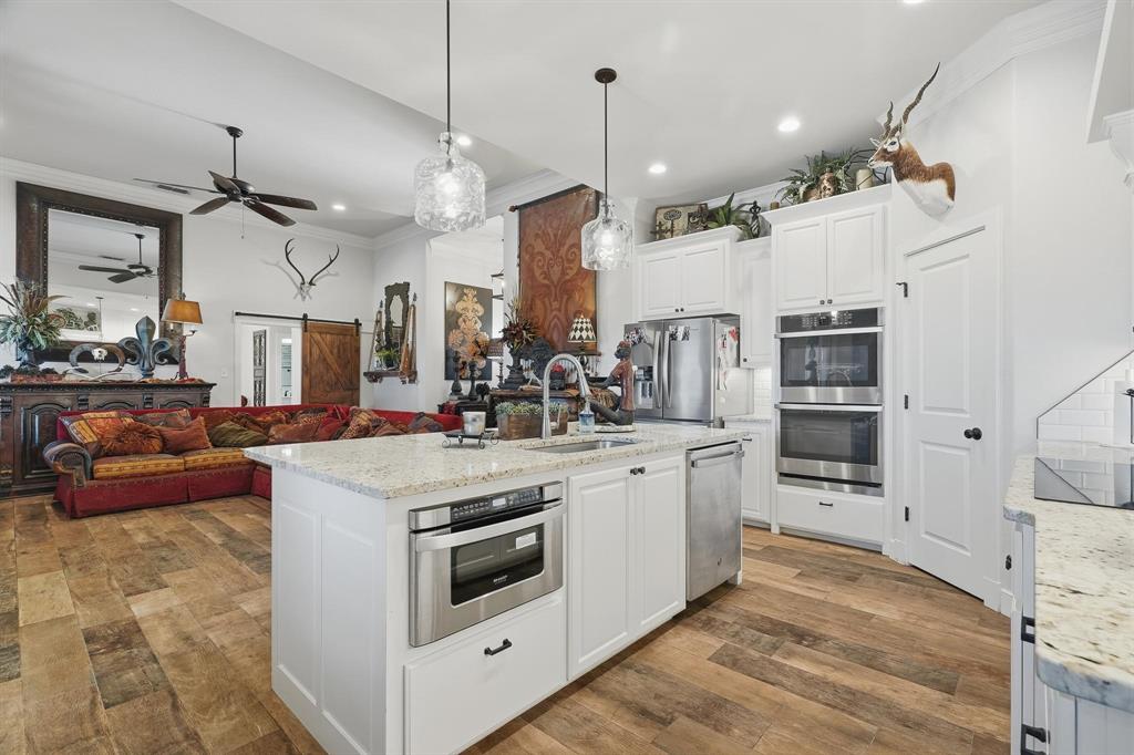 163 Homestead Road Tuscola, TX 79562 - Photo 12 of 40 a kitchen with stainless steel appliances granite countertop a stove and a refrigerator