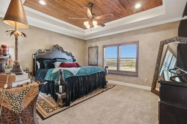 a bedroom with a bed a window and dresser