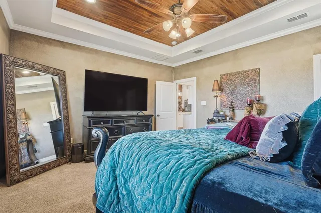 a bedroom with a large bed and a flat screen tv