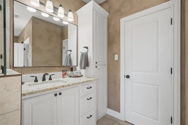 a bathroom with a double vanity sink and mirror