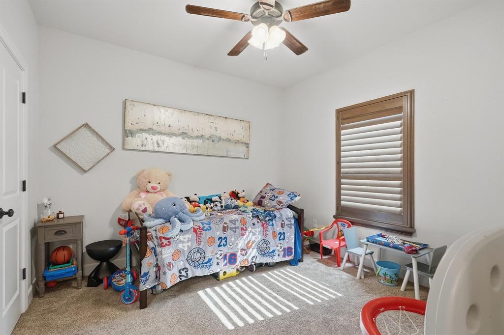 163 Homestead Road Tuscola, TX 79562 - Photo 22 of 40 a bedroom with bed and a chandelier