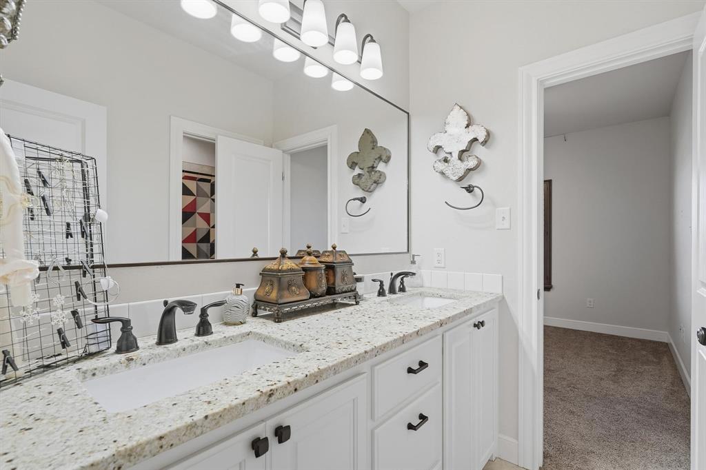 163 Homestead Road Tuscola, TX 79562 - Photo 23 of 40 a bathroom with a double vanity sink and a mirror