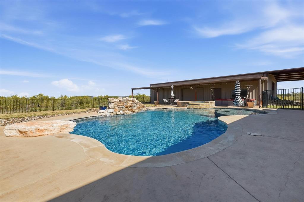 163 Homestead Road Tuscola, TX 79562 - Photo 28 of 40 a view of a swimming pool with an outdoor seating
