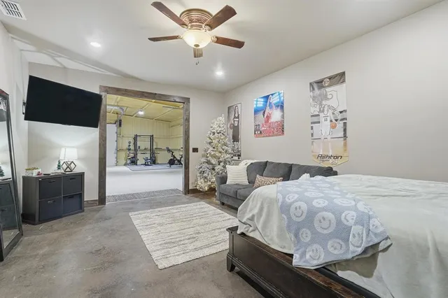 a spacious bedroom with a bed and a chandelier