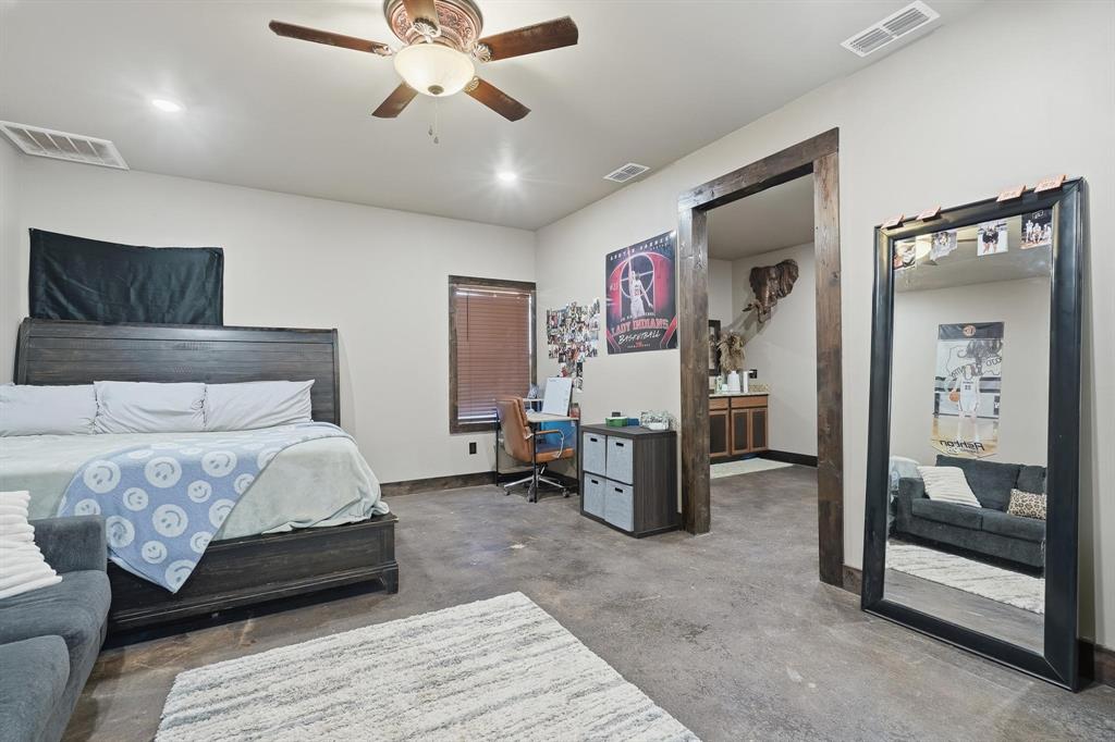 163 Homestead Road Tuscola, TX 79562 - Photo 35 of 40 a bedroom with a bed and a chandelier