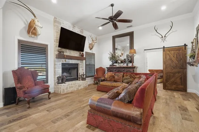 a living room with furniture a fireplace and a flat screen tv