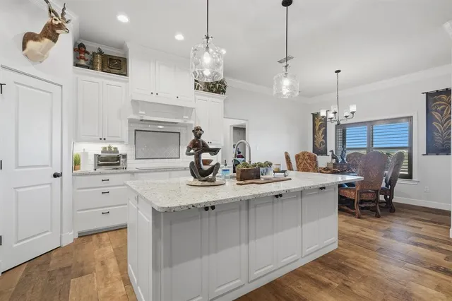 a kitchen with kitchen island white cabinets and white appliances