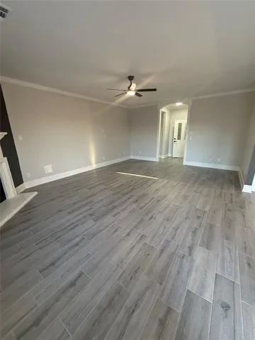 a view of a kitchen with wooden floor and electronic appliances