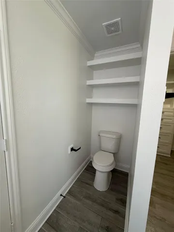 a kitchen with wooden floors and wooden cabinets