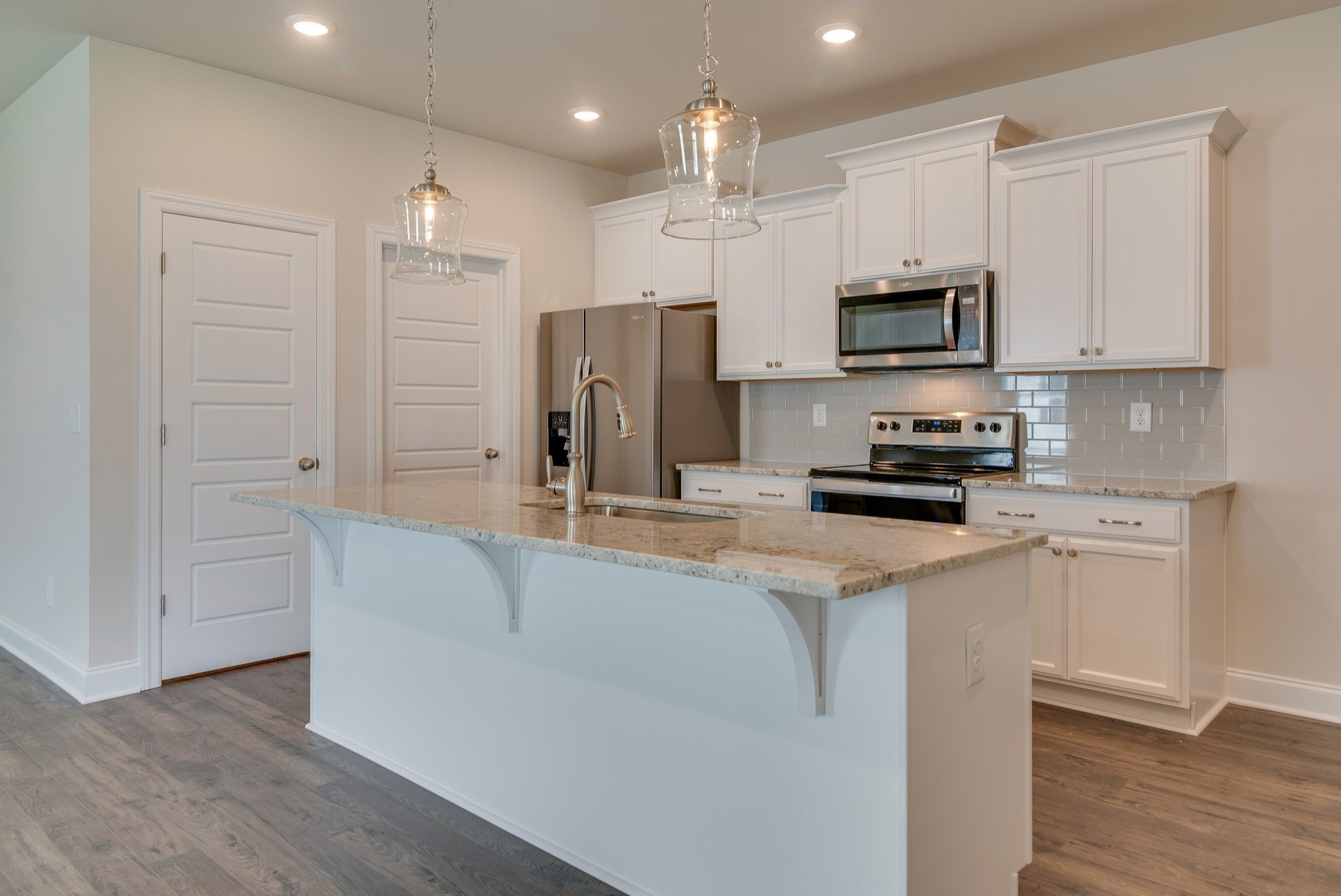 3138 Arbor Vly Road, Unit H8 Spring Hill, TN 37174 - Photo 12 of 27 a kitchen with stainless steel appliances a refrigerator stove microwave and sink