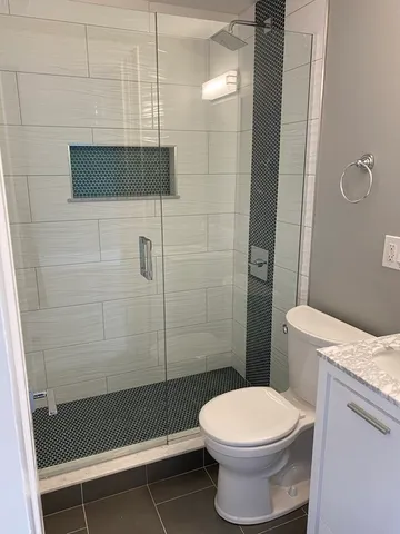 a bathroom with a toilet and a shower
