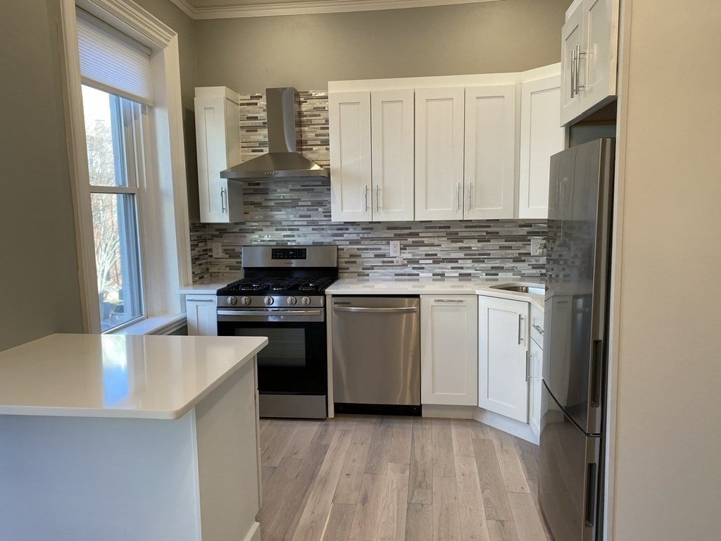 1 Wigglesworth Street, Unit 2 Boston, MA 02120 - Photo 3 of 23 a kitchen with stainless steel appliances granite countertop a stove a sink and a refrigerator