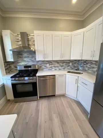 a kitchen with a stove and a sink