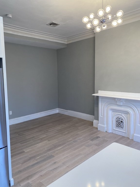 1 Wigglesworth Street, Unit 2 Boston, MA 02120 - Photo 5 of 23 a view of a room with wooden floor and chandelier