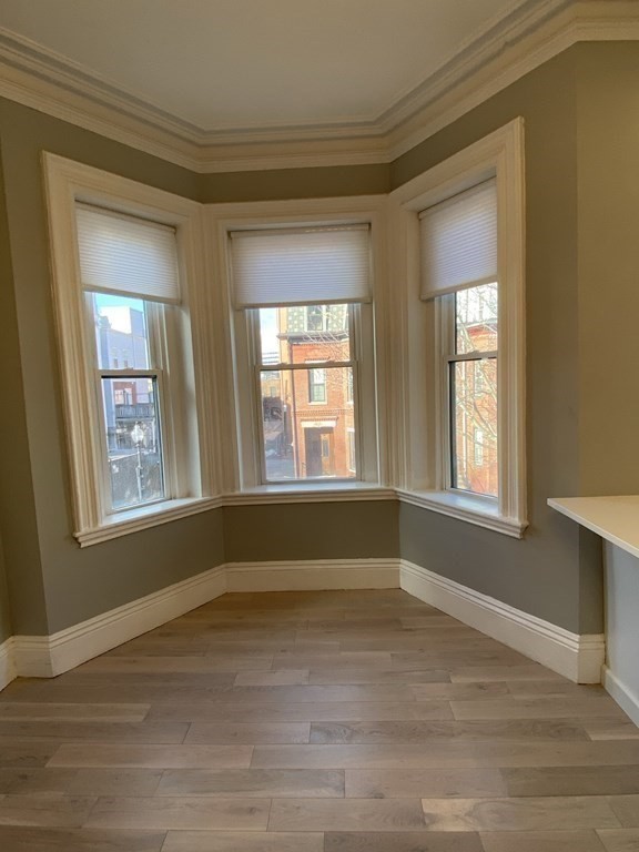 1 Wigglesworth Street, Unit 2 Boston, MA 02120 - Photo 7 of 23 a view of an empty room with wooden floor and a window