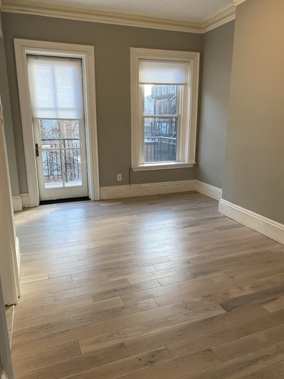1 Wigglesworth Street, Unit 2 Boston, MA 02120 - Photo 8 of 23 a view of an empty room with wooden floor and a window