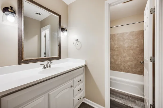a bathroom with a shower and a bath tub
