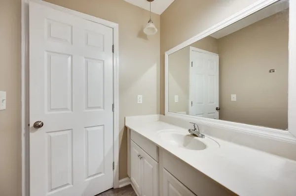 a bathroom with a sink and mirror