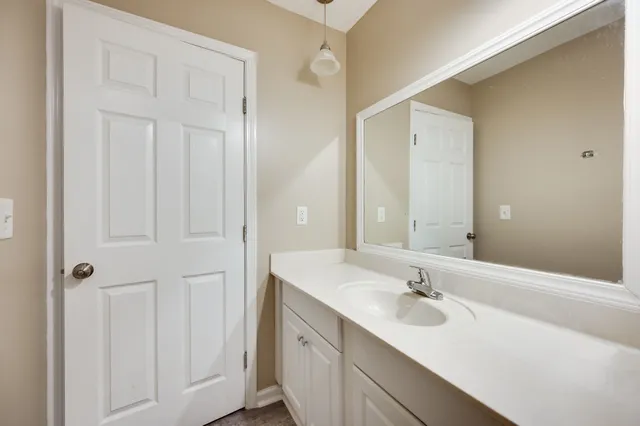 a bathroom with a sink and mirror