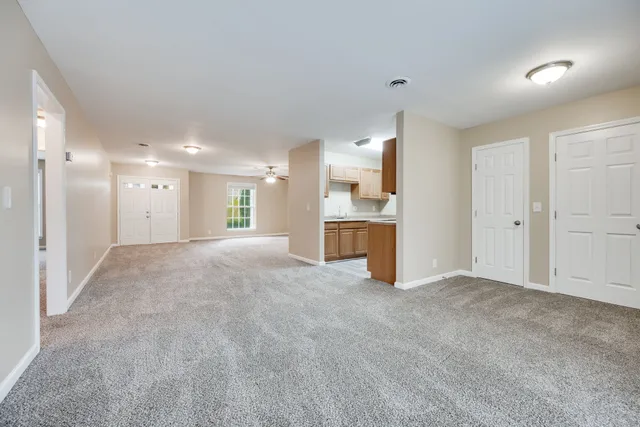 a view of a kitchen with a sink and a refrigerator