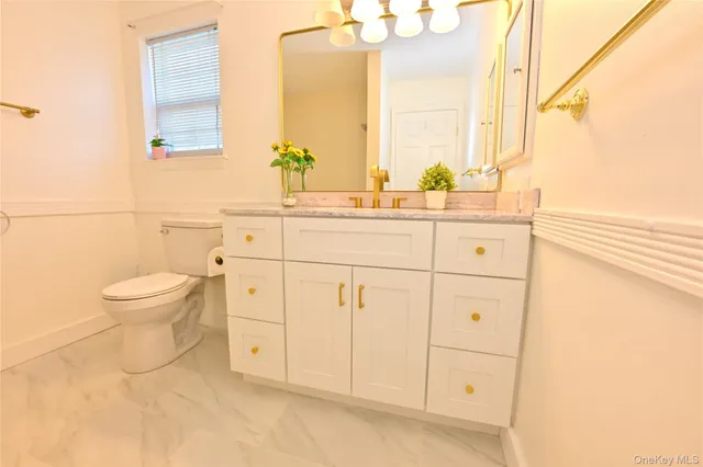 a bathroom with a toilet sink and mirror