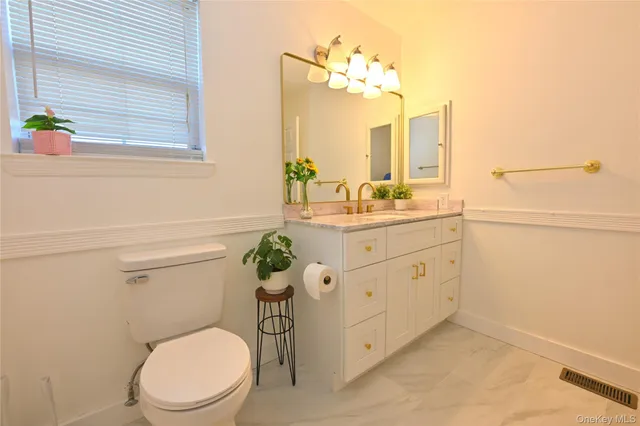 a bathroom with a toilet a sink and a window