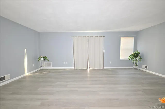 a view of an empty room with potted plants