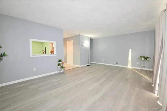 a view of a room with gym equipment and a window
