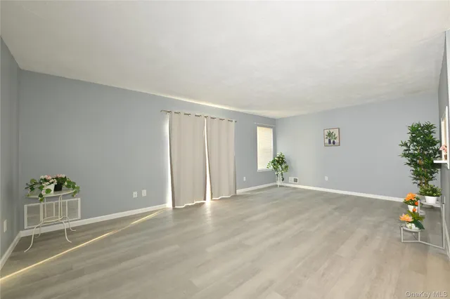 a view of an empty room and wooden floor