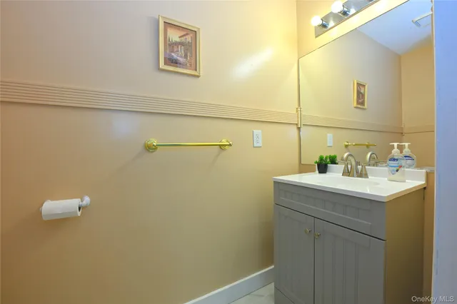 a bathroom with a sink a mirror and vanity