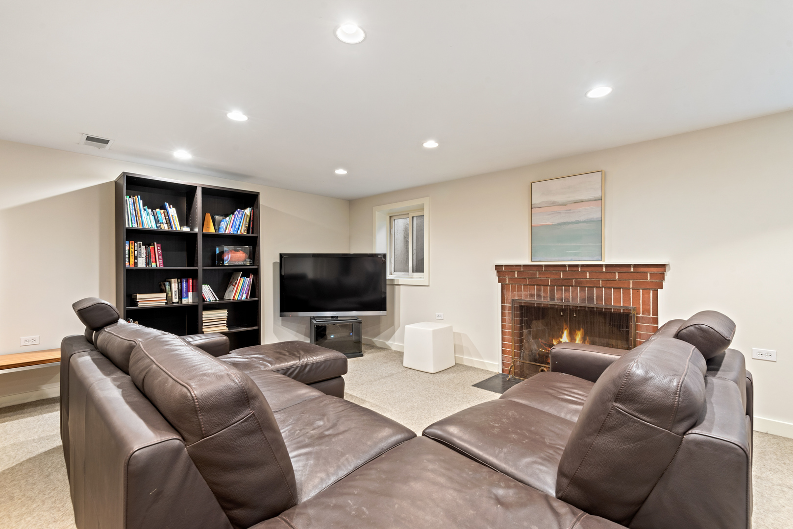 700 Park Drive Kenilworth, IL 60043 - Photo 27 of 34 a living room with furniture a fireplace and a flat screen tv