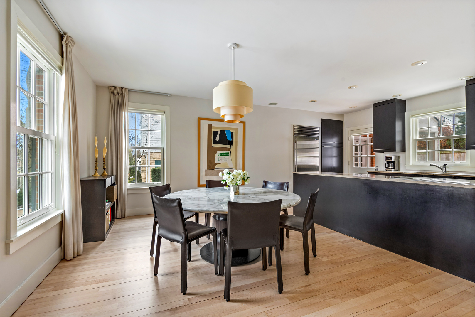 700 Park Drive Kenilworth, IL 60043 - Photo 4 of 34 a dining room with wooden floor a chandelier a wooden table and chairs