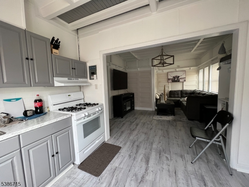 324 Summer Avenue, Unit 3 Newark, NJ 07104 - Photo 1 of 12 a kitchen with sink cabinets and wooden floor