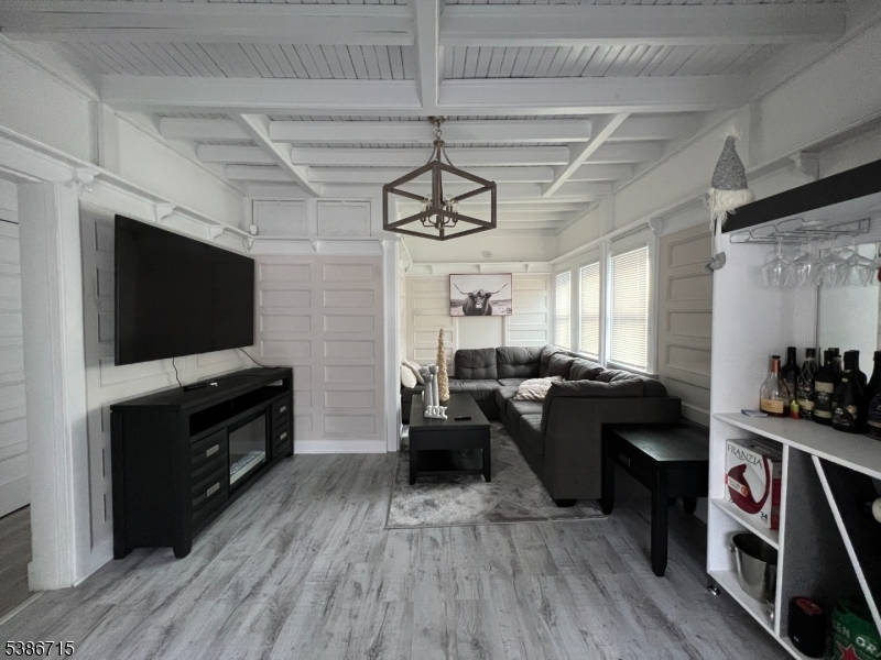 324 Summer Avenue, Unit 3 Newark, NJ 07104 - Photo 5 of 12 a living room with furniture and a flat screen tv
