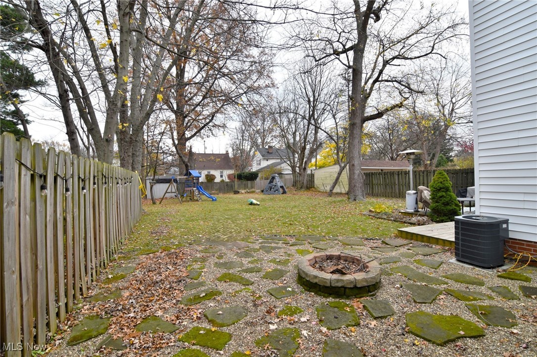 1767 Edgefield Road Lyndhurst, OH 44124 - Photo 15 of 17 View of yard with a playground, a patio area, and a fire pit